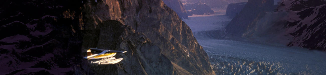 An aircraft flies over a stunning mountain